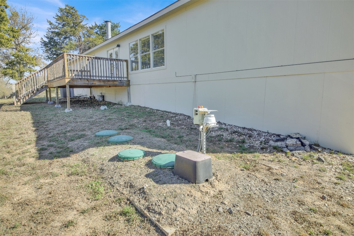 120 Webberwood Way Elgin, TX 78621 - Photo 32 of 36 View of property exterior featuring stairway and a deck