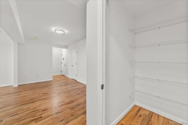a view of hallway with wooden floor