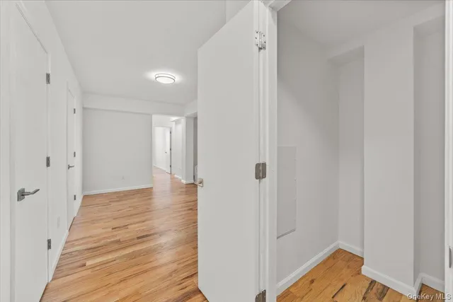 a view of a room with wooden floor and white walls