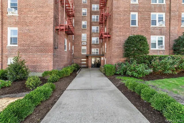 a view of a brick building next to a yard