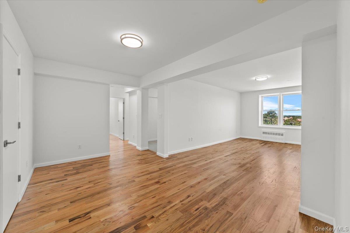 90 Union Street, Unit 6G New Rochelle, NY 10805 - Photo 4 of 20 a view of a livingroom with wooden floor and a large window
