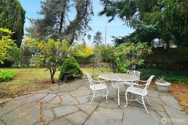 a view of a chairs and table in backyard of the house