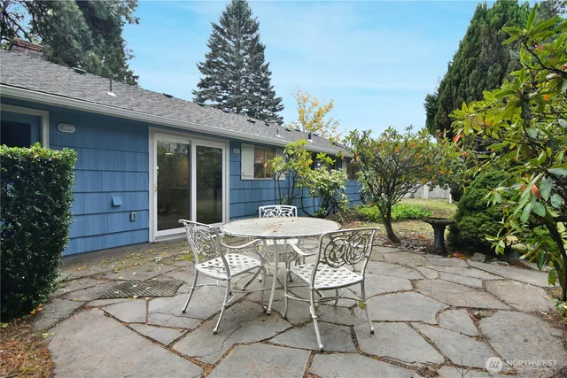 a view of a patio with table and chairs and potted plants