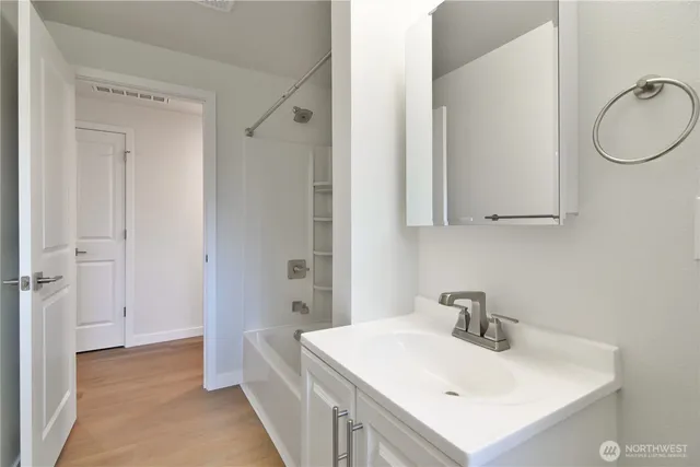 a bathroom with a sink a vanity and a mirror