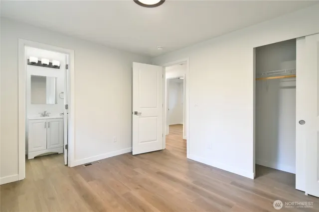 a view of a room with wooden floor