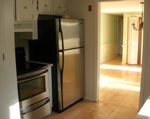 14 Westminster Road Centerville, MA 02632 - Photo 4 of 5 a kitchen with a refrigerator and cabinets
