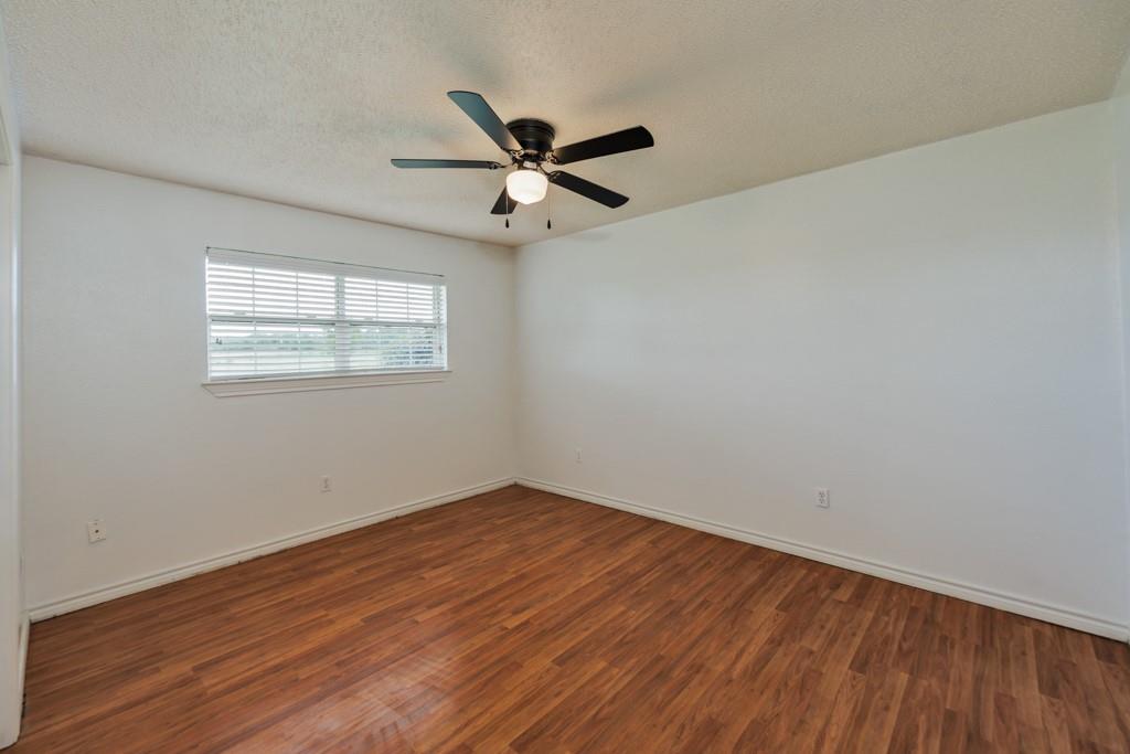 4316 Leona Road Bowie, TX 76230 - Photo 19 of 37 wooden floor in an empty room with a window