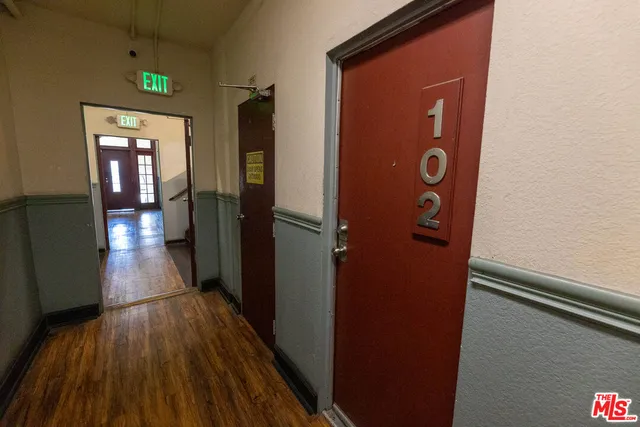 a view of a hallway with wooden floor