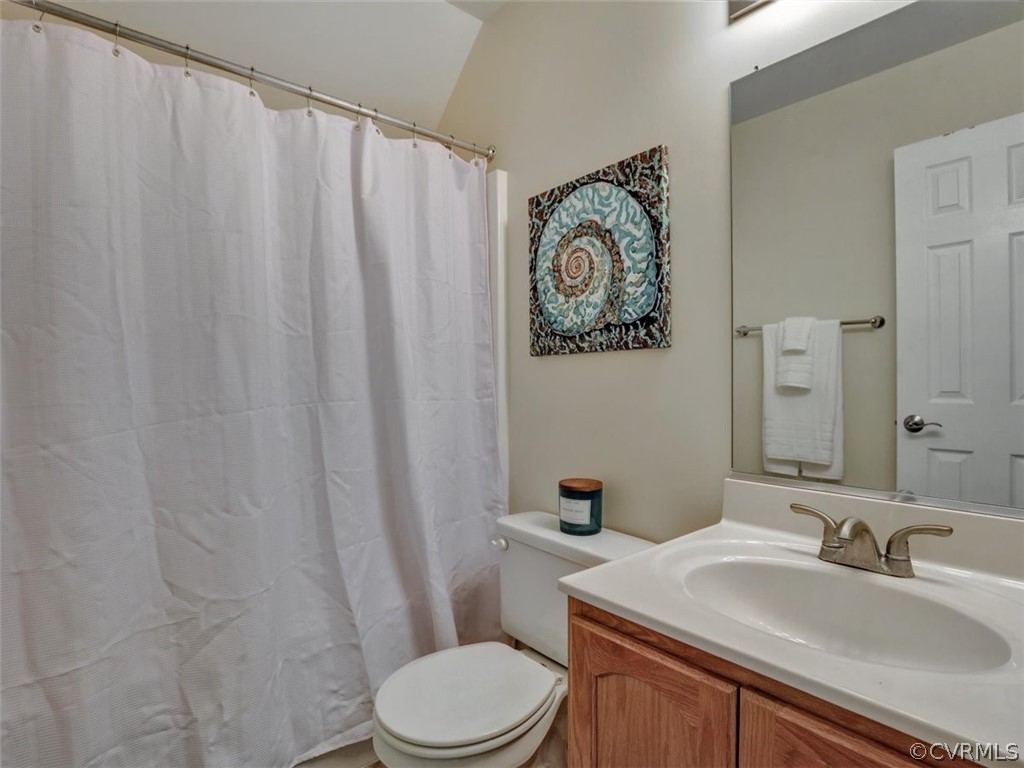 20037 Ivan Road Petersburg, VA 23803 - Photo 36 of 41 a bathroom with a sink a toilet and shower curtain