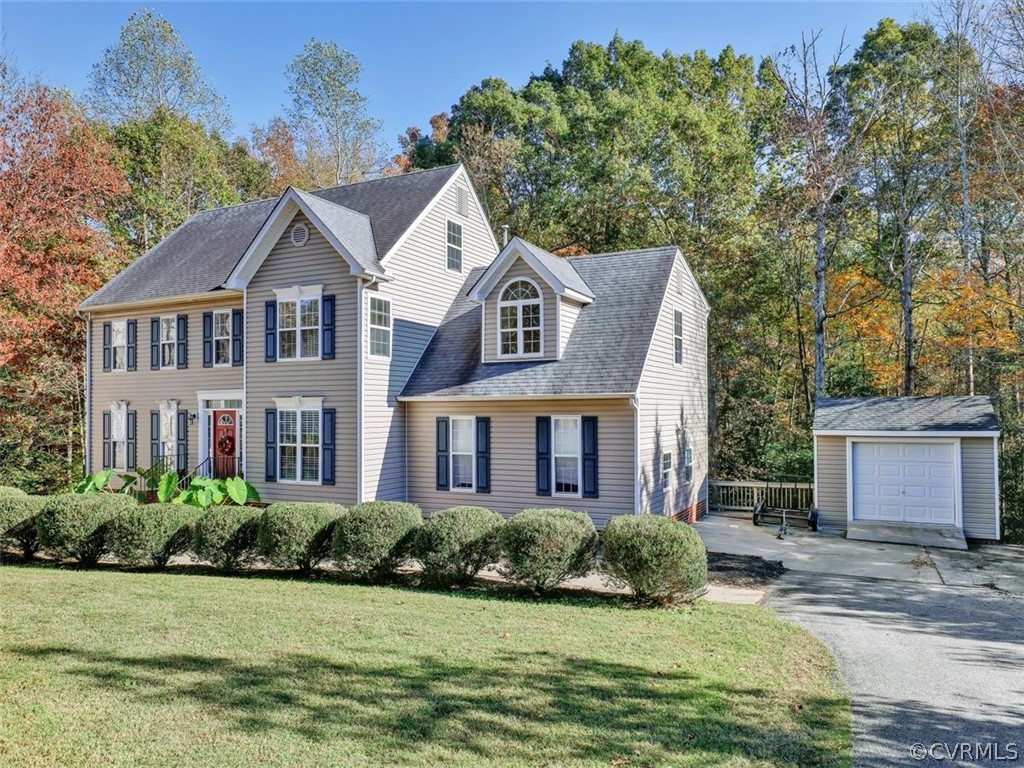 20037 Ivan Road Petersburg, VA 23803 - Photo 4 of 41 a front view of a house with a garden and yard
