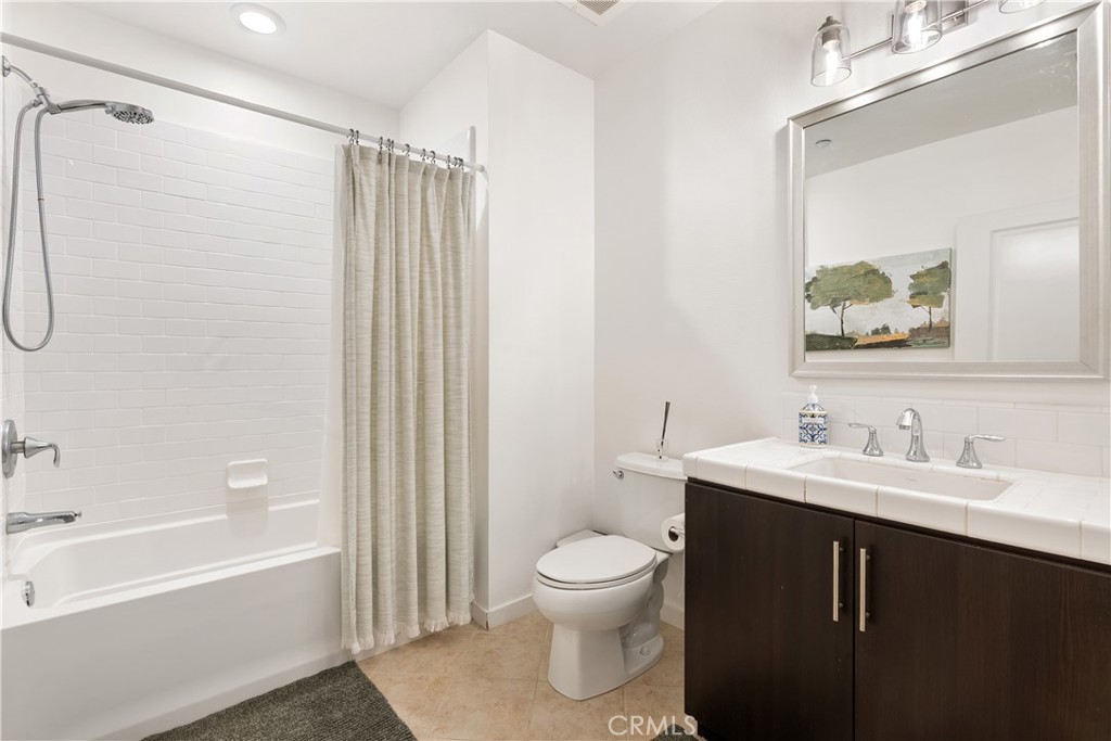 21 Gramercy, Unit 102 Irvine, CA 92612 - Photo 14 of 30 Spa inspired bathroom featuring dual sinks, modern finishes, and generous counter space.