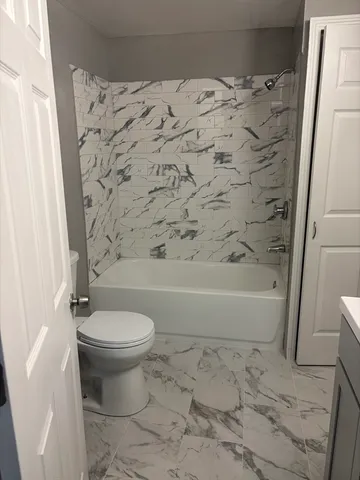 a bathroom with a bathtub and toilet