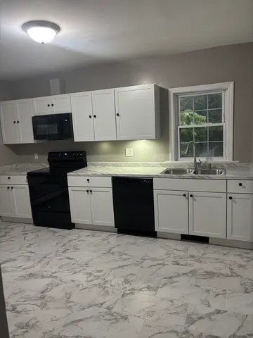 a kitchen with a sink and cabinets