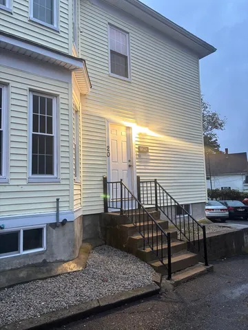 a view of a house with a yard and wooden floor