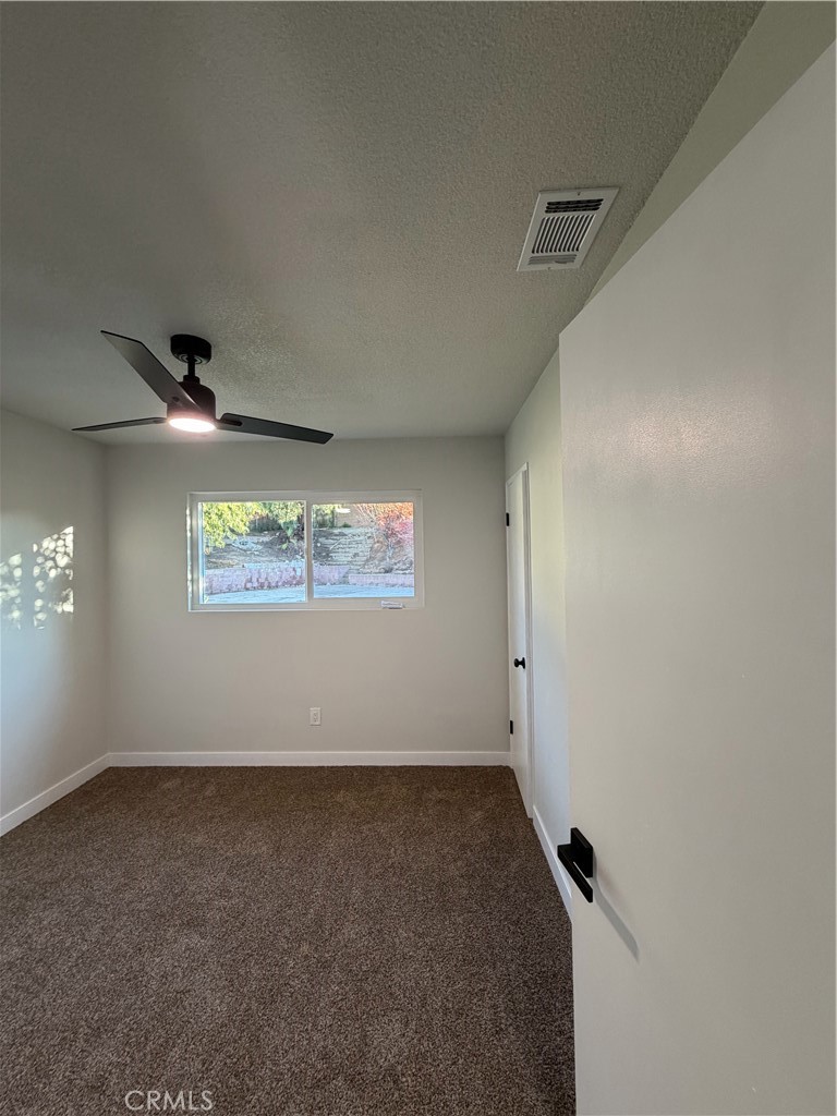 2579 Spring Meadow Lane Highland, CA 92346 - Photo 13 of 17 an empty room with a window
