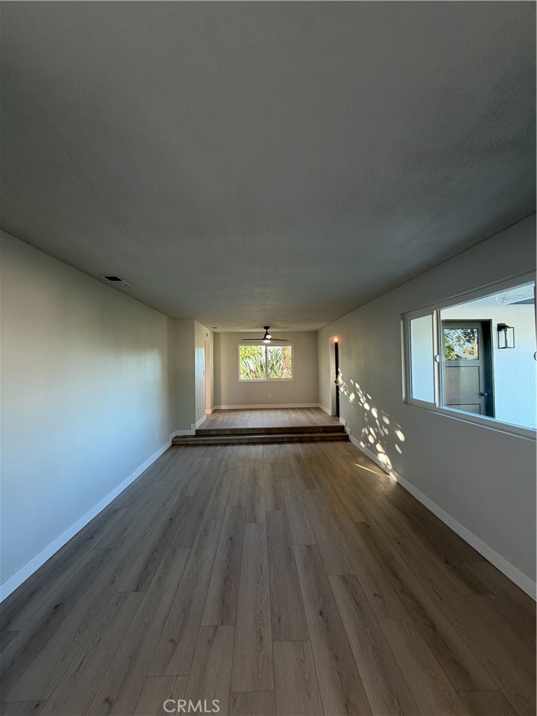 2579 Spring Meadow Lane Highland, CA 92346 - Photo 2 of 17 an empty room with wooden floor and windows