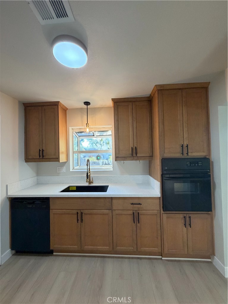 2579 Spring Meadow Lane Highland, CA 92346 - Photo 4 of 17 a kitchen with a sink and cabinets
