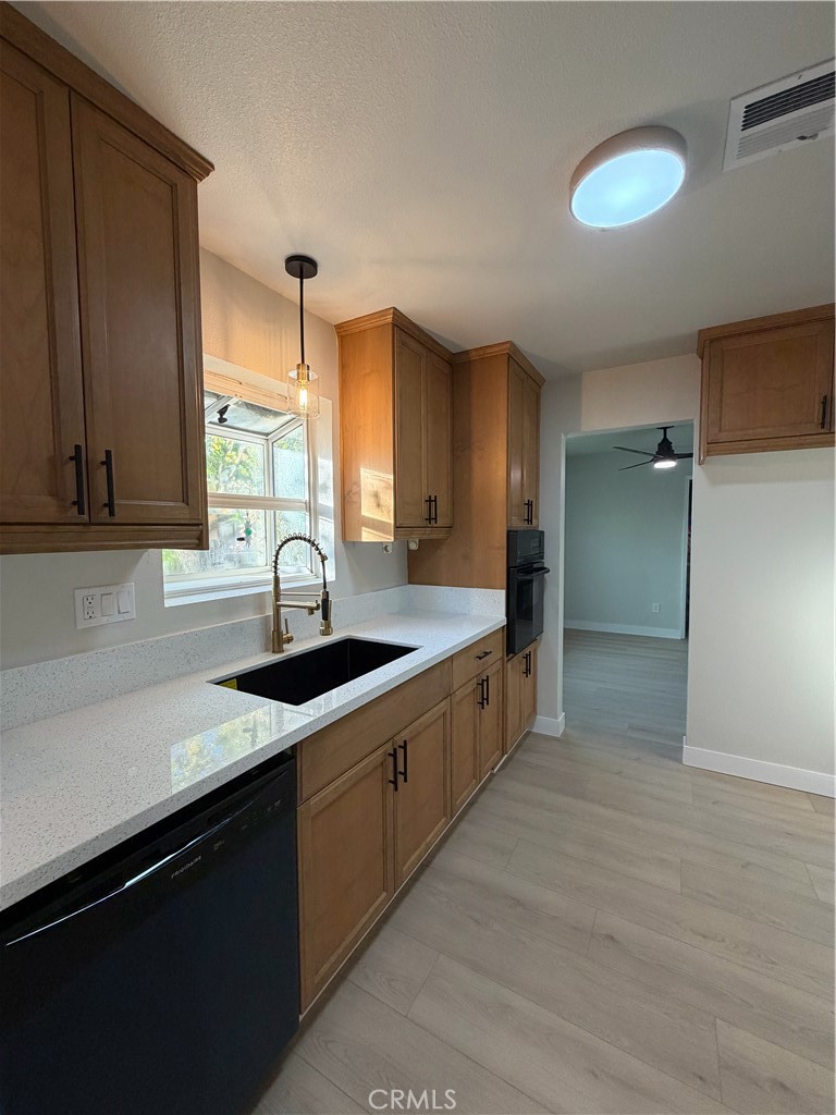 2579 Spring Meadow Lane Highland, CA 92346 - Photo 5 of 17 a kitchen with granite countertop a sink and a stove