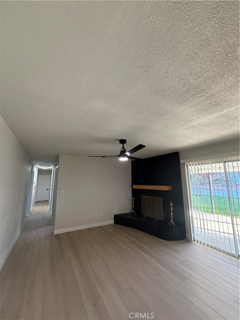 2579 Spring Meadow Lane Highland, CA 92346 - Photo 6 of 17 an empty room with windows and fireplace