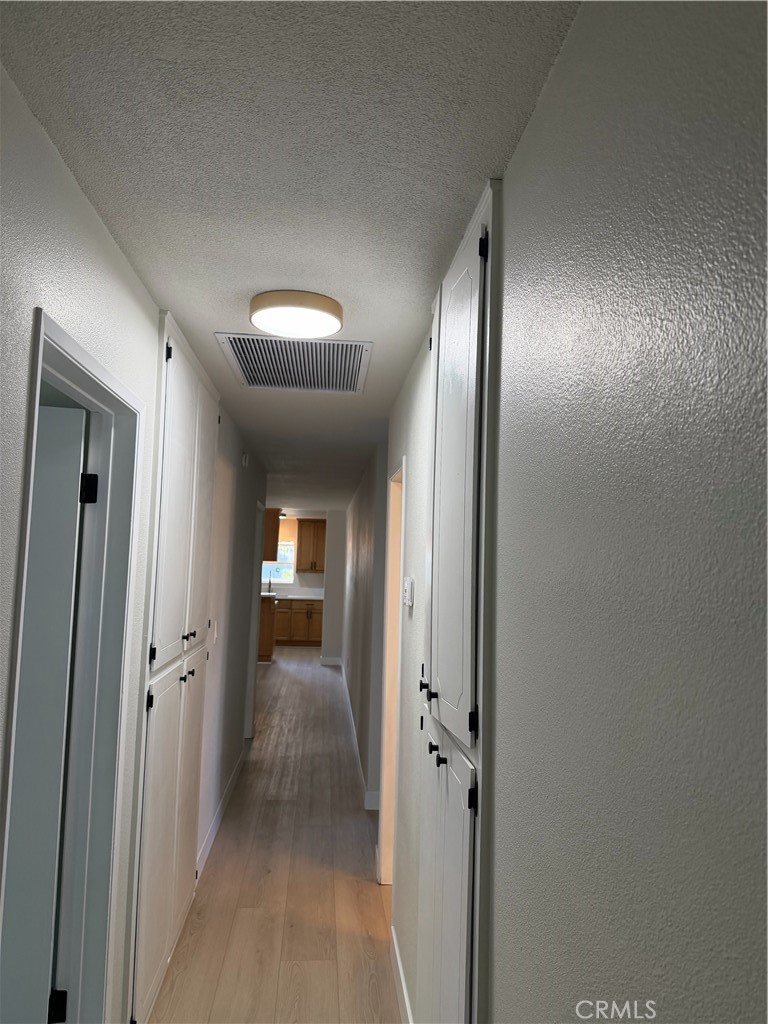 2579 Spring Meadow Lane Highland, CA 92346 - Photo 10 of 17 a view of a hallway view with wooden floor and staircase