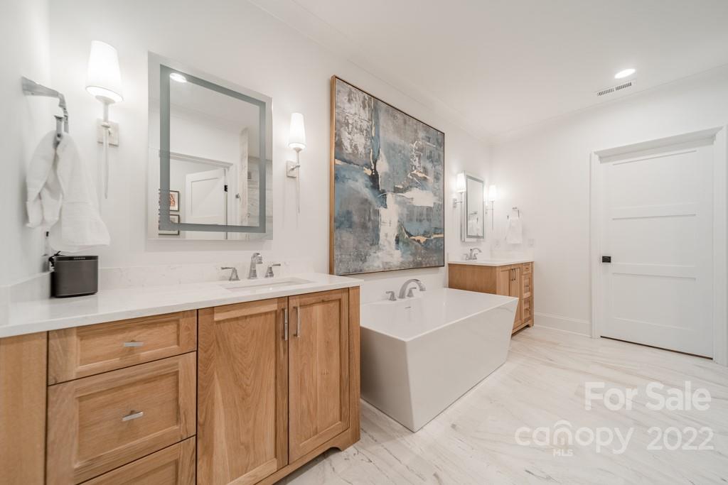 2801 Sharon Road Charlotte, NC 28211 - Photo 36 of 45 a large bathroom with a tub a sink and mirror