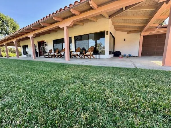 a group of people sitting in a yard