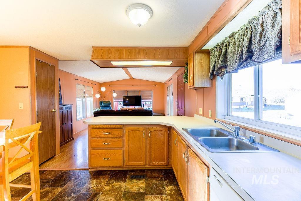 4325 Lenville Road, Unit 34 Moscow, ID 83843 - Photo 38 of 39 Kitchen with open floor plan, a peninsula, light countertops, lofted ceiling, and brown cabinets