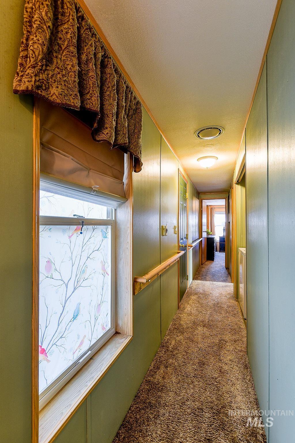 4325 Lenville Road, Unit 34 Moscow, ID 83843 - Photo 20 of 39 Corridor with carpet flooring and a decorative wall