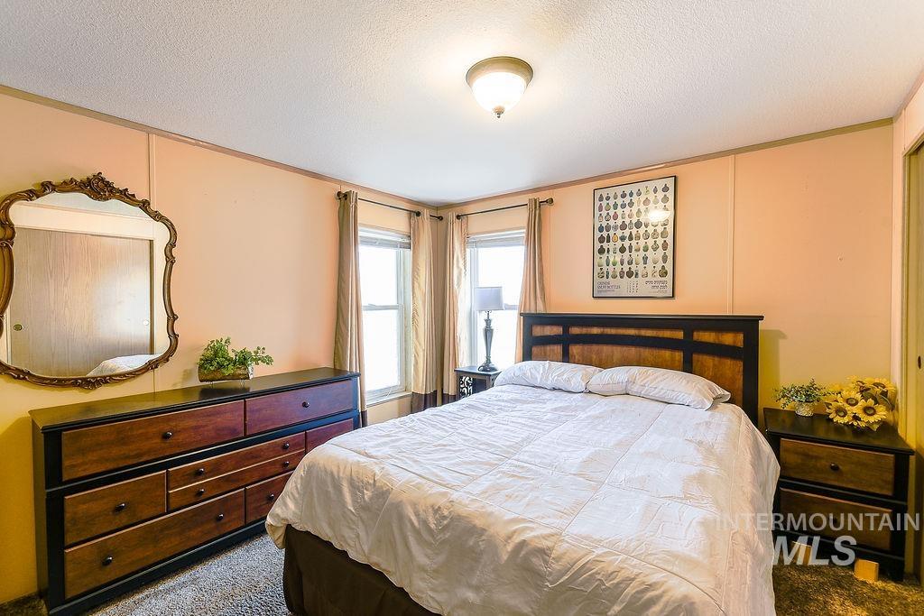 4325 Lenville Road, Unit 34 Moscow, ID 83843 - Photo 30 of 39 Carpeted bedroom with a textured ceiling and crown molding