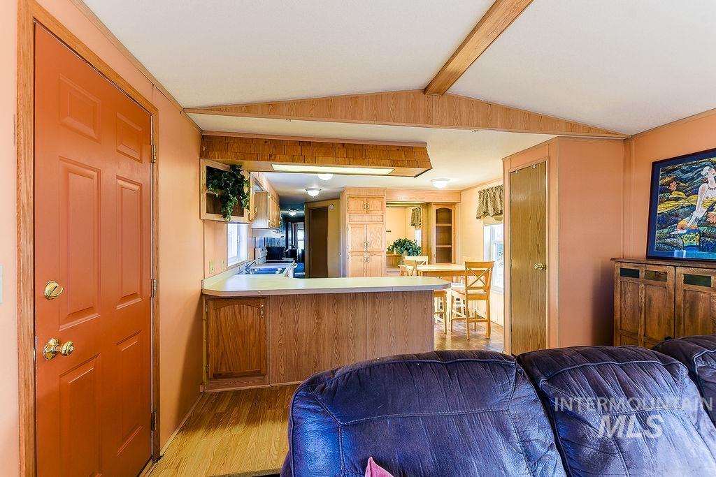 4325 Lenville Road, Unit 34 Moscow, ID 83843 - Photo 37 of 39 Kitchen with light wood finished floors, light countertops, open floor plan, a peninsula, and brown cabinets