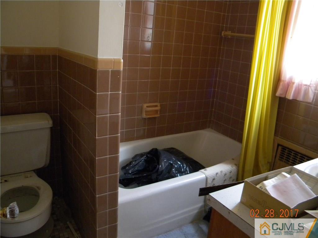 20 3rd Street Somerville, NJ 08876 - Photo 9 of 12 a bathroom with a toilet a sink and a shower