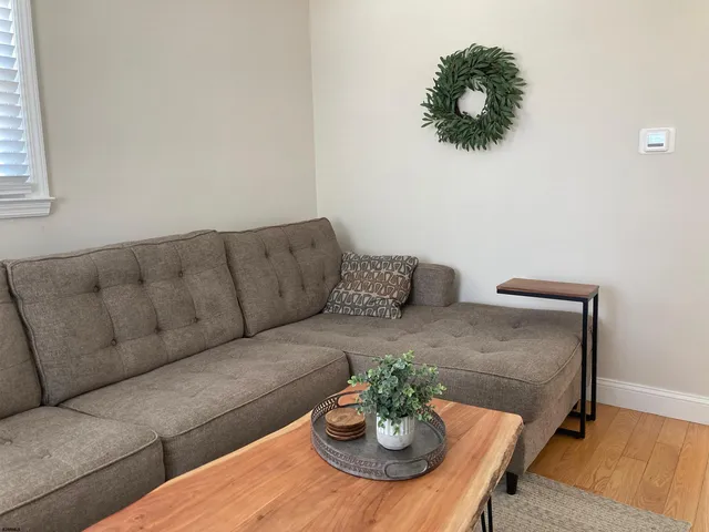 a living room with furniture and a dining table