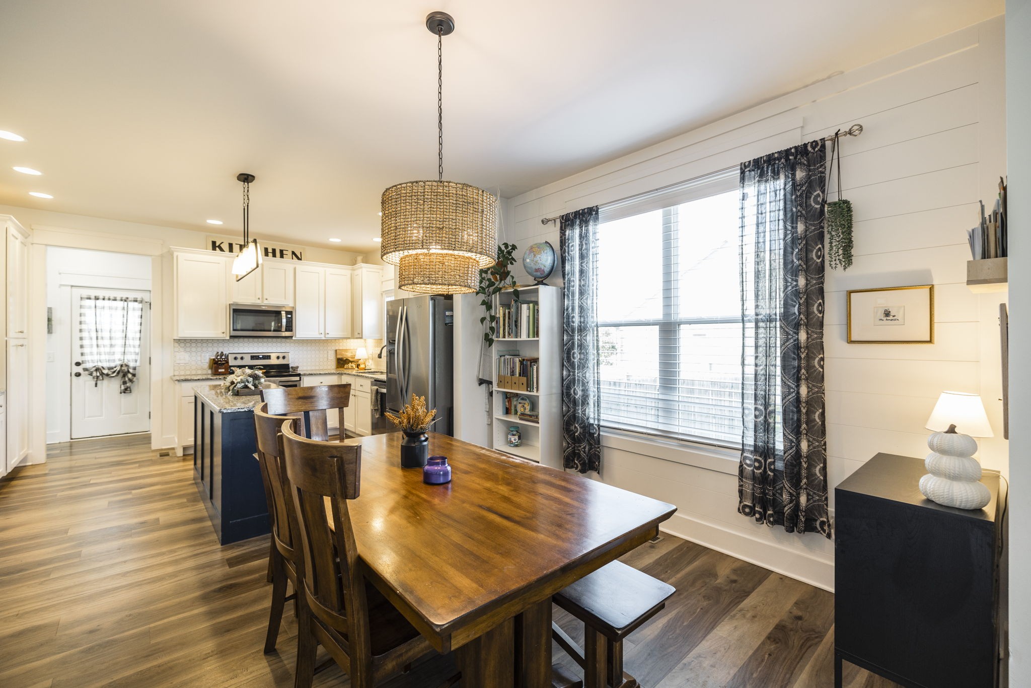 324 East Biggs Road Portland, TN 37148 - Photo 36 of 57 a view of a dining room and livingroom with furniture wooden floor a chandelier