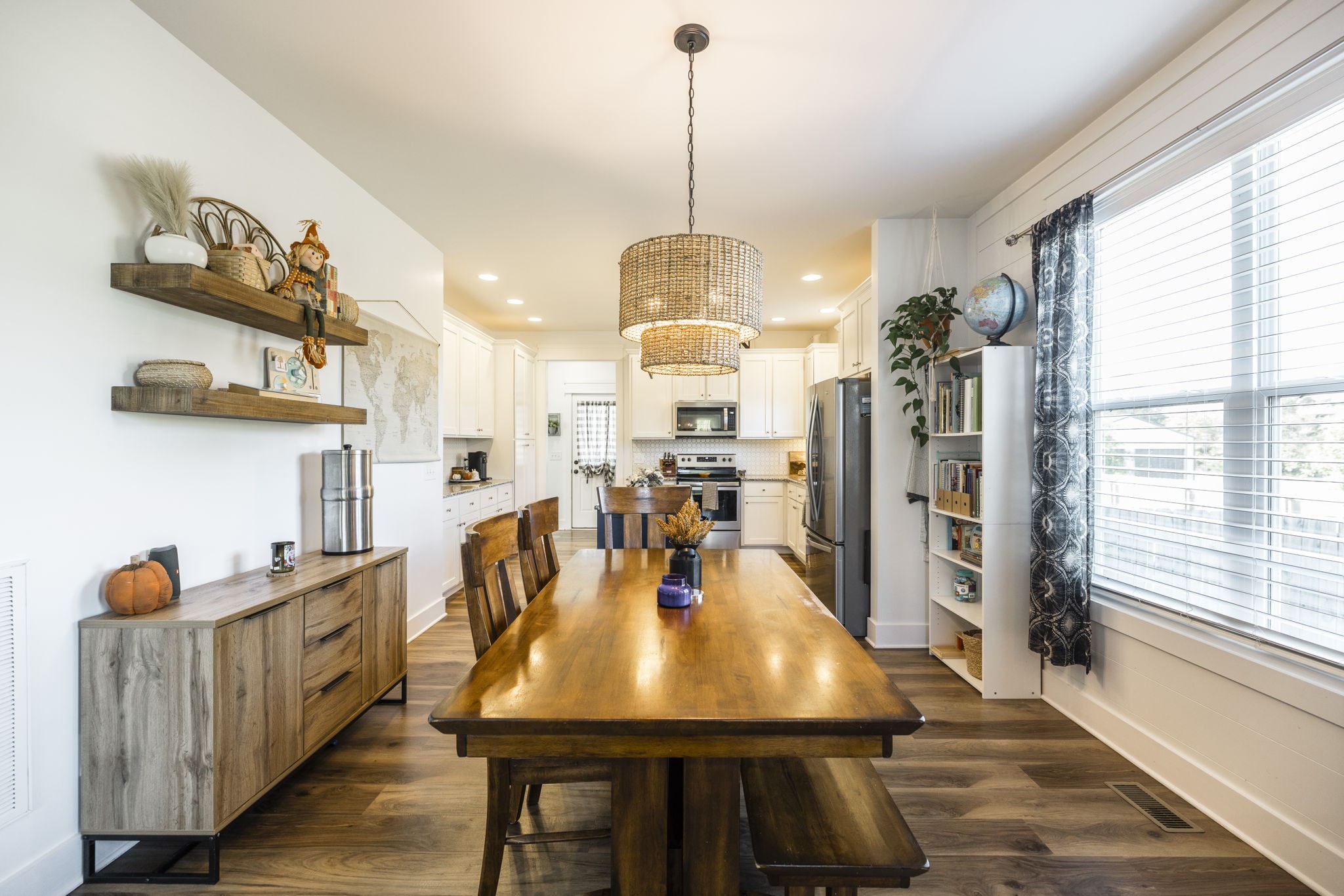 324 East Biggs Road Portland, TN 37148 - Photo 37 of 57 a view of a dining room and livingroom with furniture wooden floor a chandelier