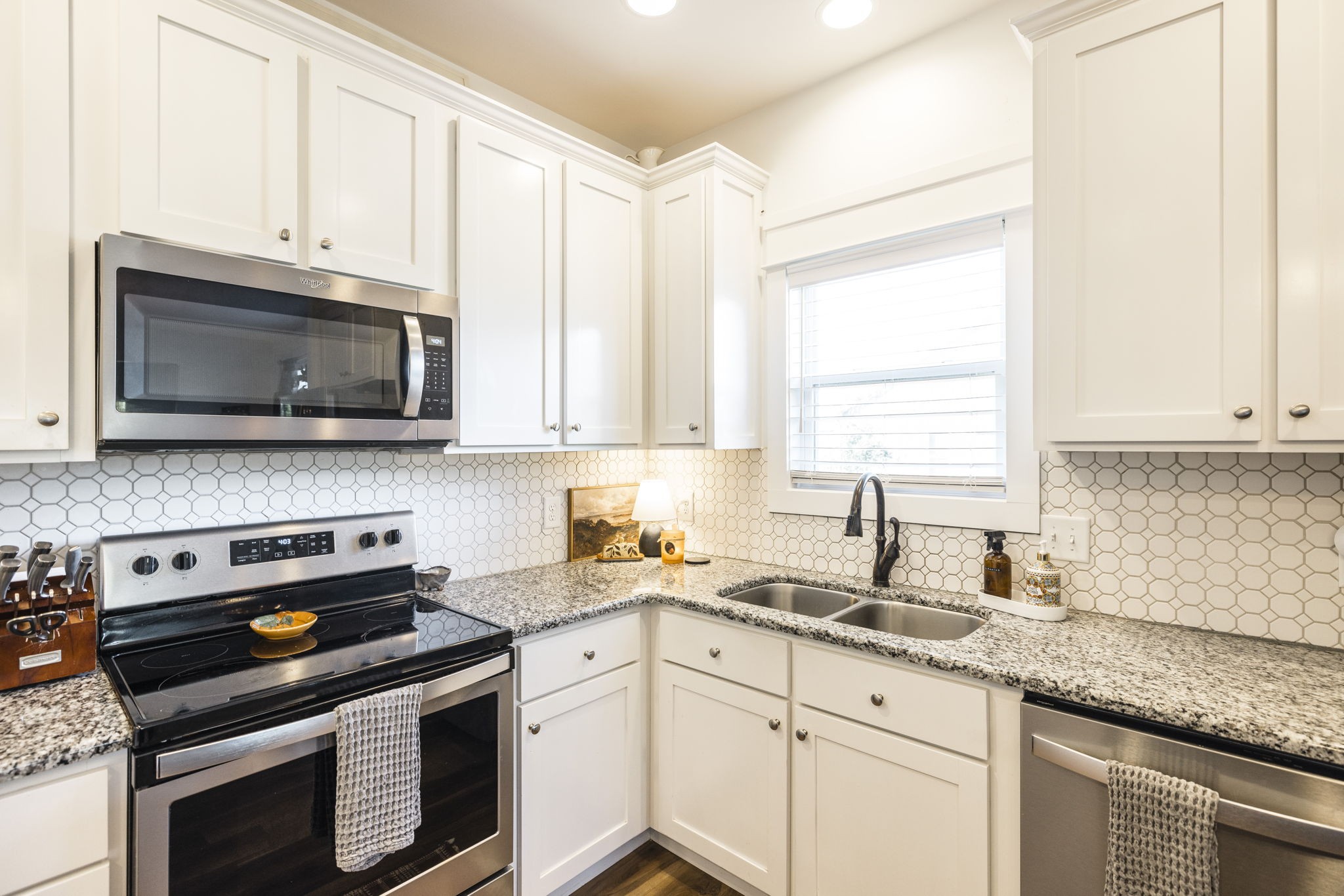 324 East Biggs Road Portland, TN 37148 - Photo 41 of 57 a kitchen with granite countertop white cabinets and appliances