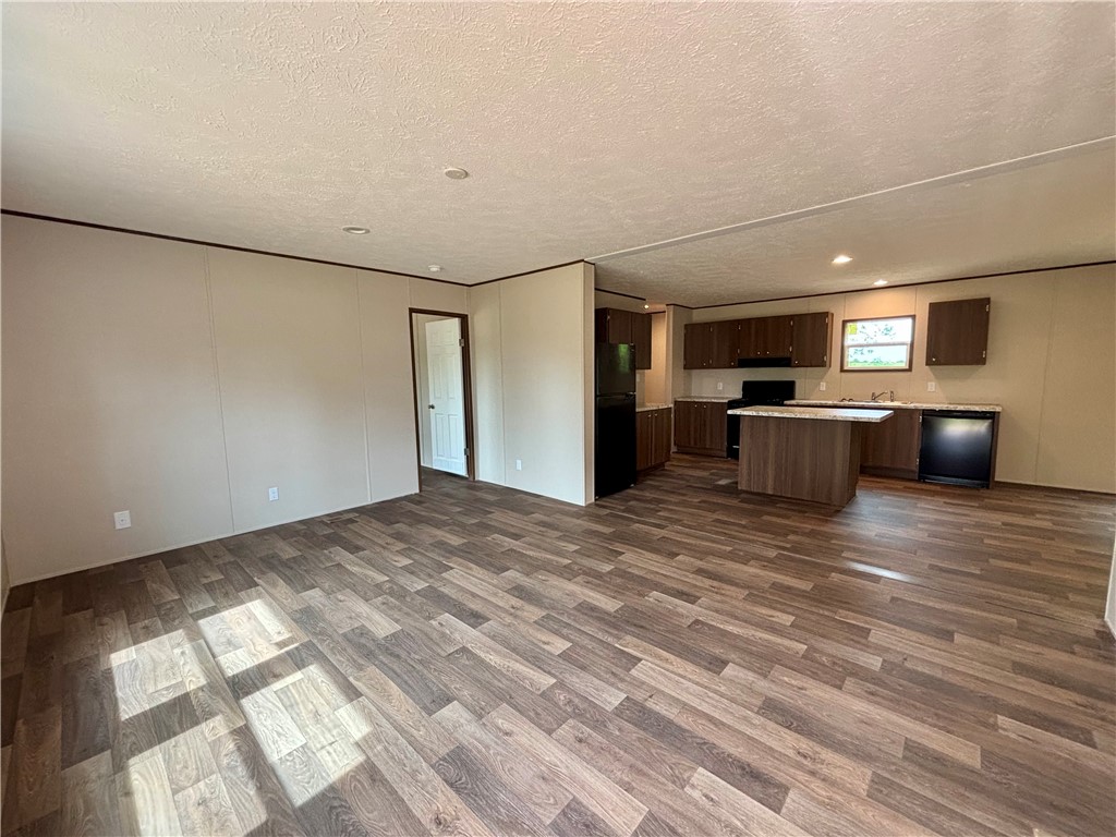 703 Double Springs Road Townville, SC 29689 - Photo 6 of 22 This open-concept space blends living and cooking areas with durable, easy-care flooring.