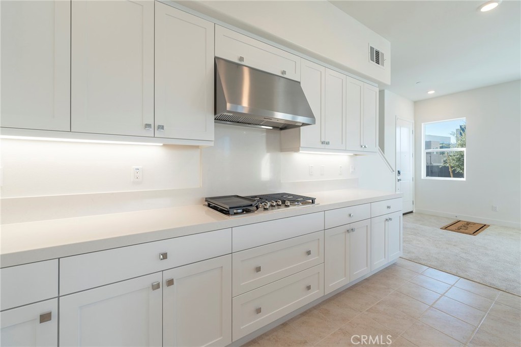 121 Baluster Irvine, CA 92618 - Photo 11 of 80 a kitchen with white cabinets and white appliances