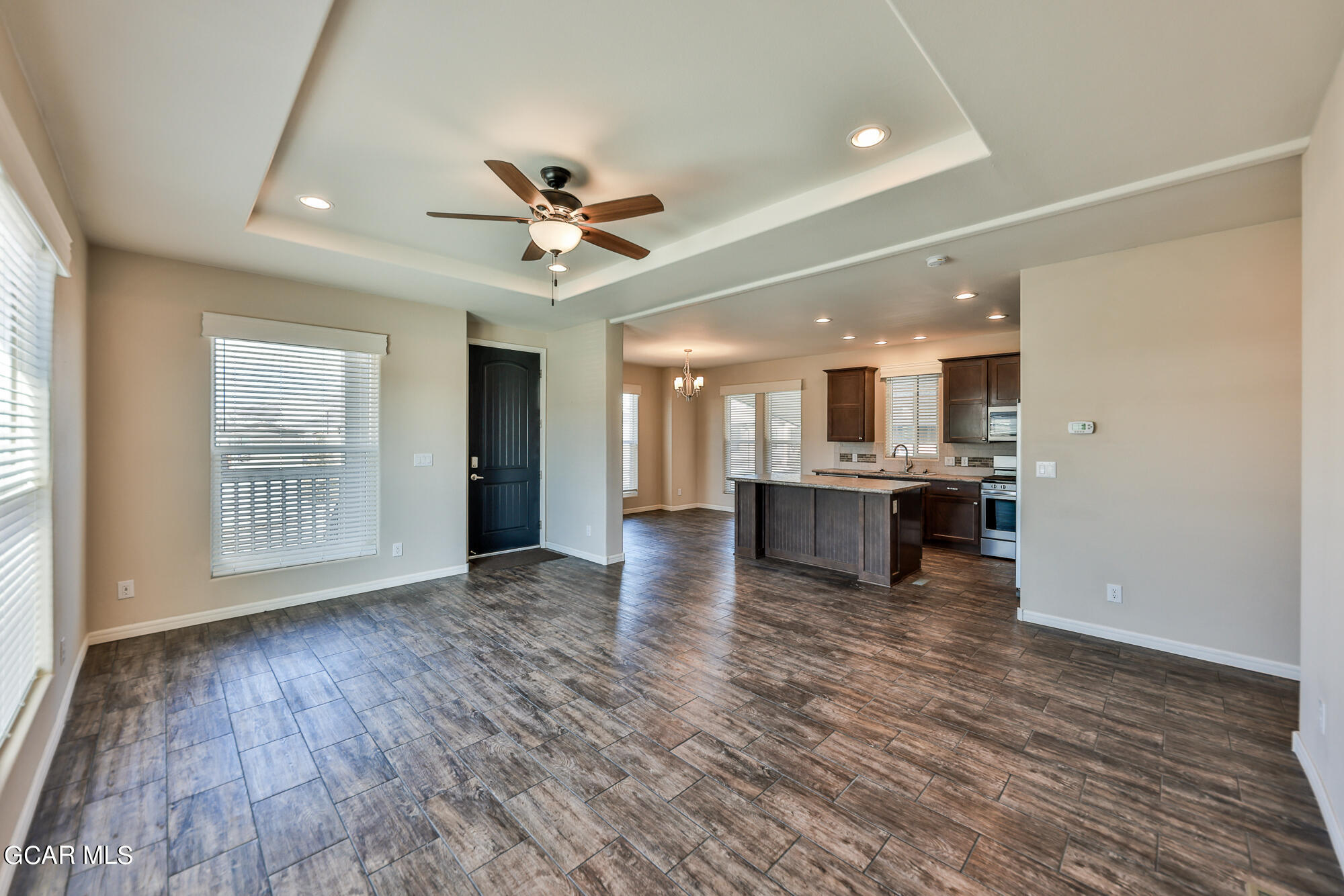 551 Summit Trail, Unit 145 Granby, CO 80446 - Photo 14 of 39 a view of an empty room and kitchen with furniture wooden floor