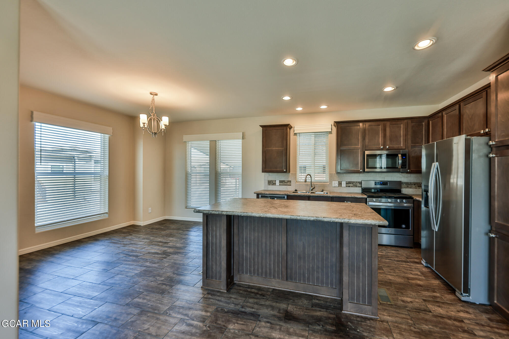 551 Summit Trail, Unit 145 Granby, CO 80446 - Photo 16 of 39 a large kitchen with kitchen island a sink stainless steel appliances and cabinets