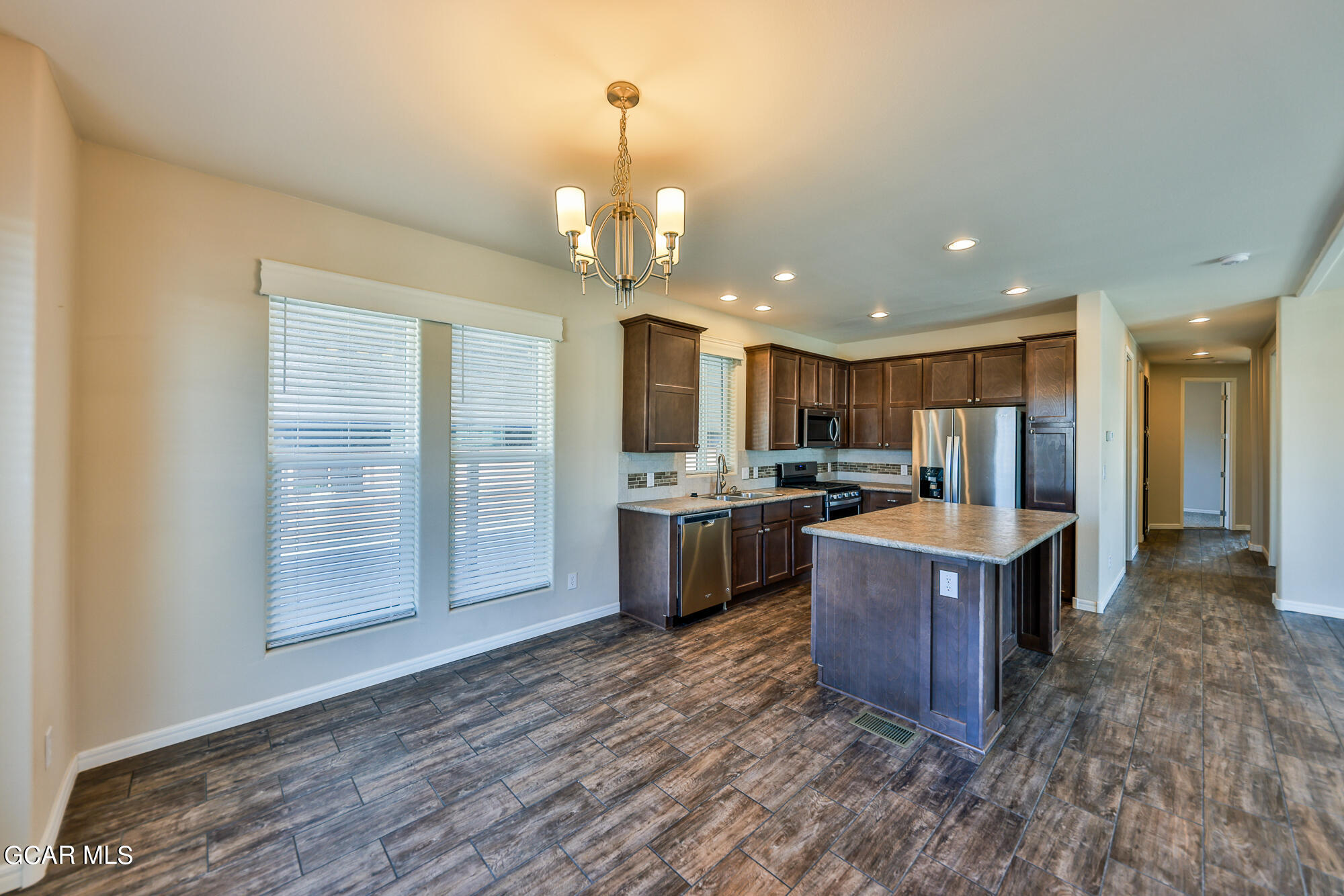551 Summit Trail, Unit 145 Granby, CO 80446 - Photo 17 of 39 a large kitchen with kitchen island a sink stainless steel appliances and cabinets