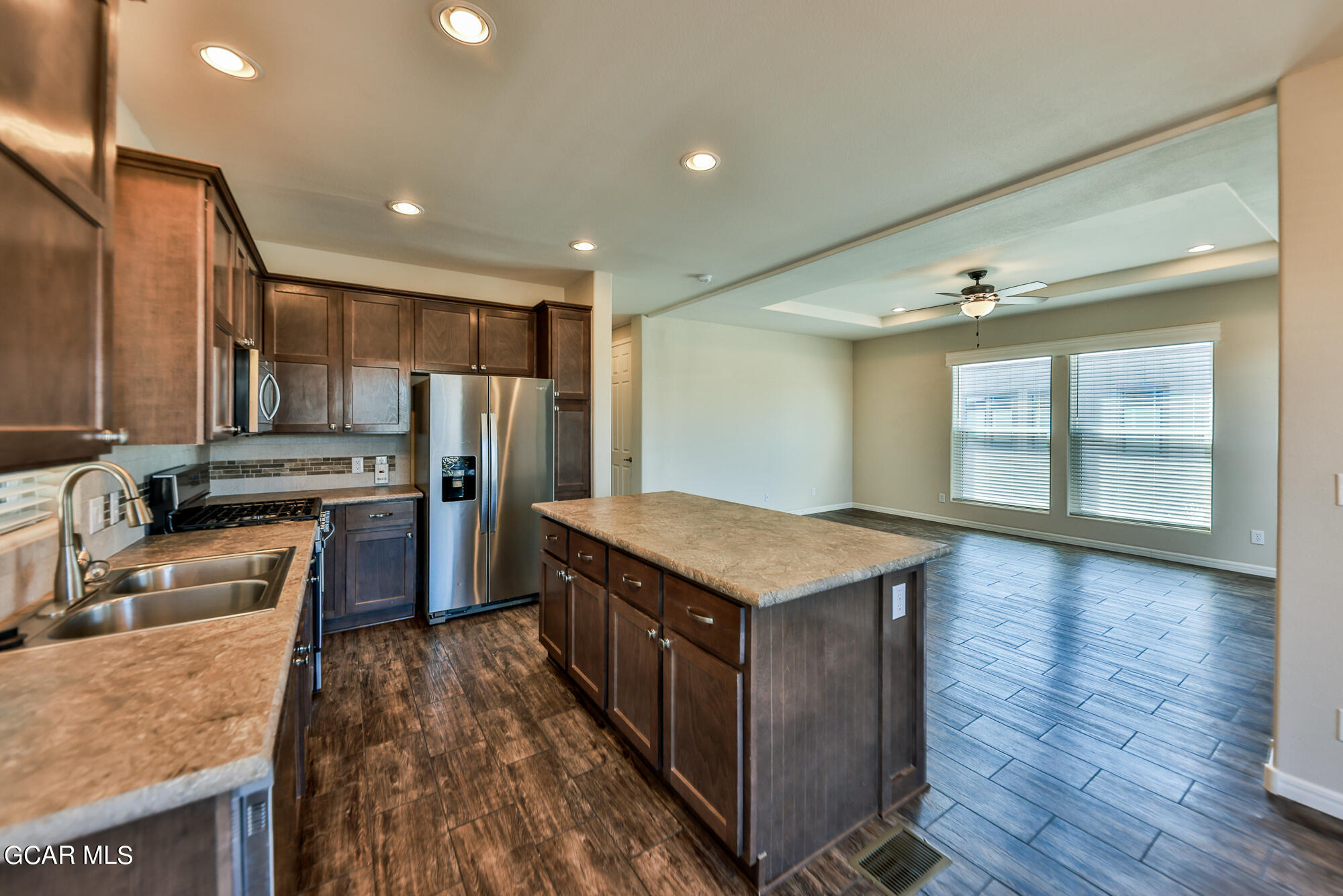 551 Summit Trail, Unit 145 Granby, CO 80446 - Photo 19 of 39 a kitchen with stainless steel appliances granite countertop a stove a refrigerator and a sink