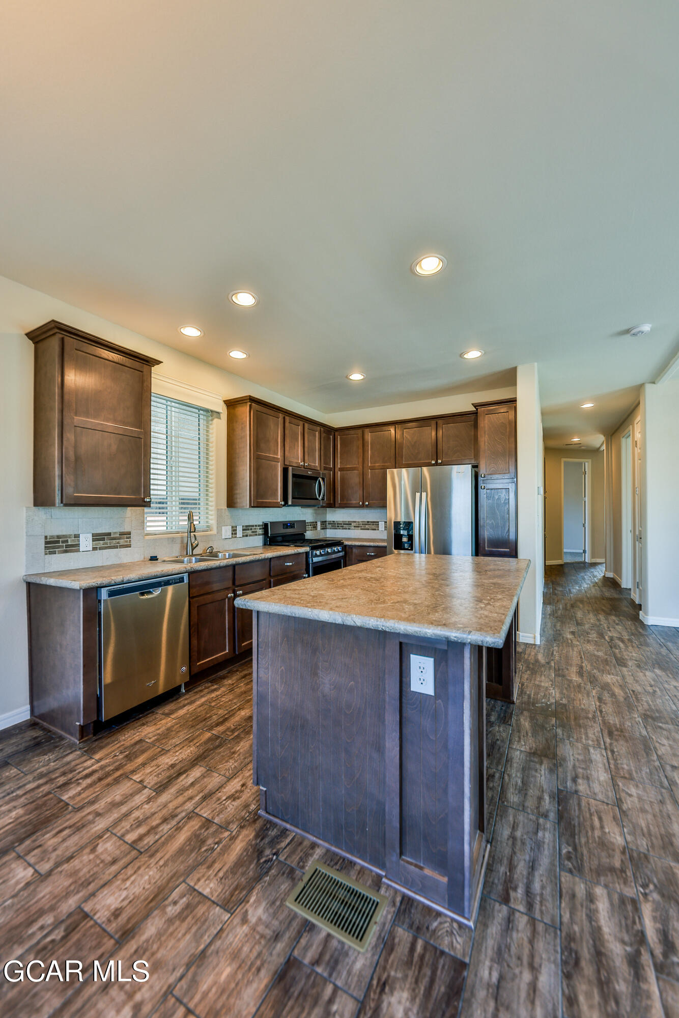 551 Summit Trail, Unit 145 Granby, CO 80446 - Photo 21 of 39 a kitchen with stainless steel appliances granite countertop a sink counter space and wooden floor