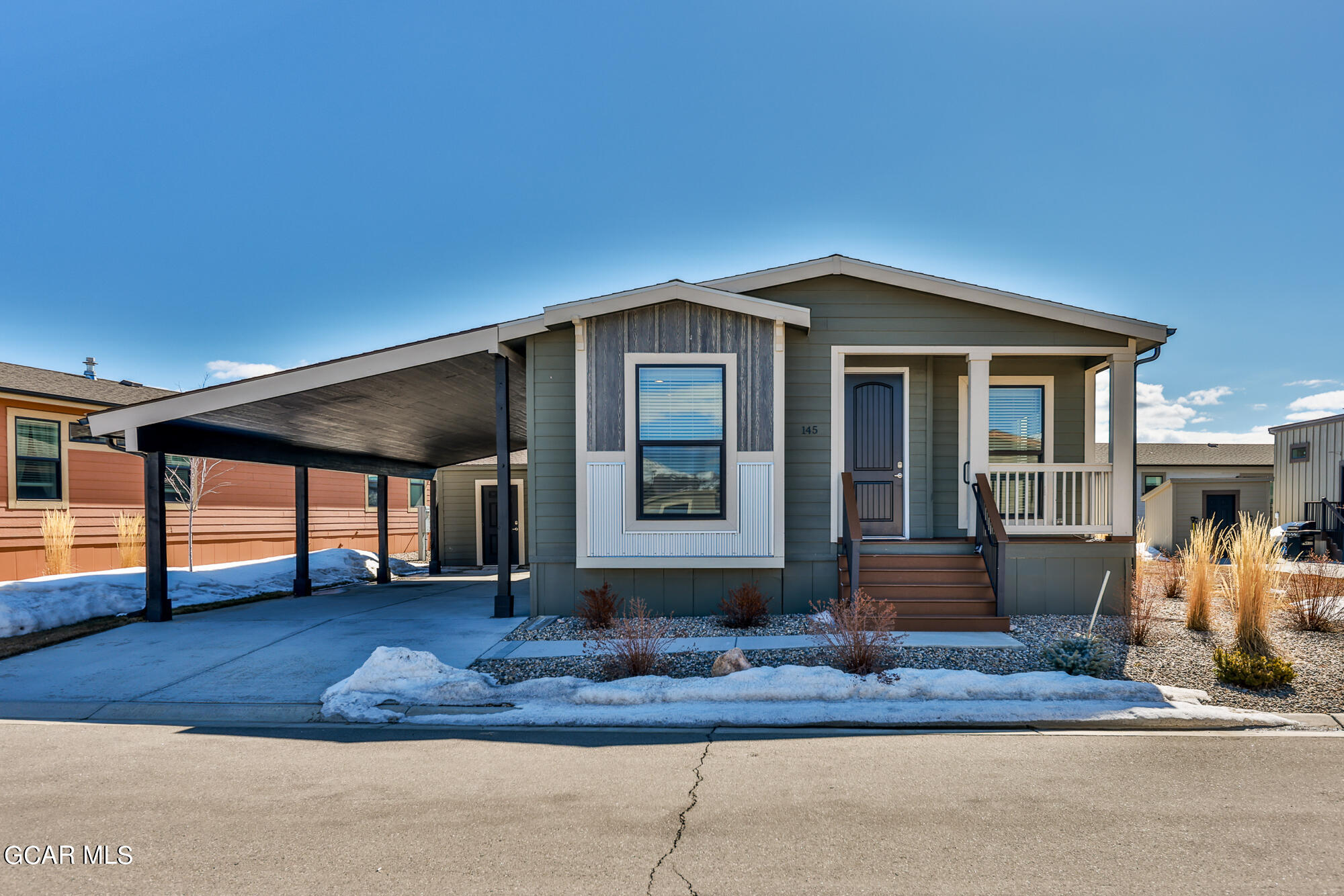 551 Summit Trail, Unit 145 Granby, CO 80446 - Photo 3 of 39 a front view of a house with garden