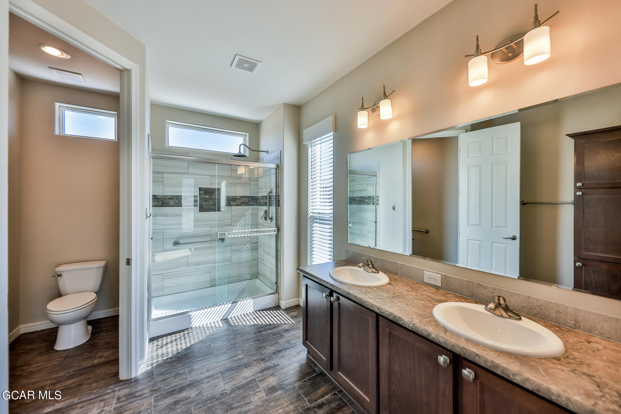 551 Summit Trail, Unit 145 Granby, CO 80446 - Photo 35 of 39 a bathroom with a granite countertop sink toilet and shower