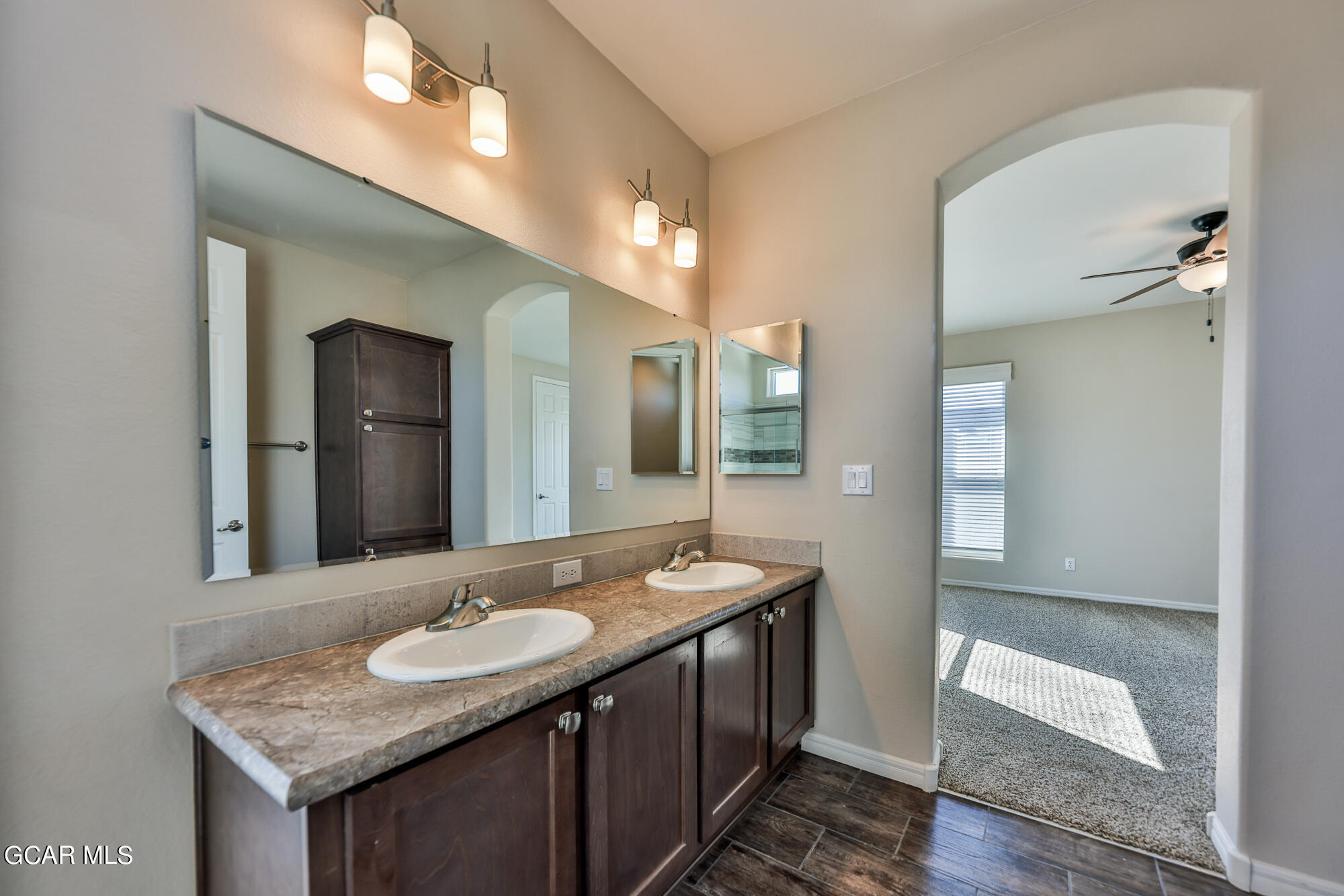 551 Summit Trail, Unit 145 Granby, CO 80446 - Photo 37 of 39 a bathroom with a granite countertop sink and a mirror