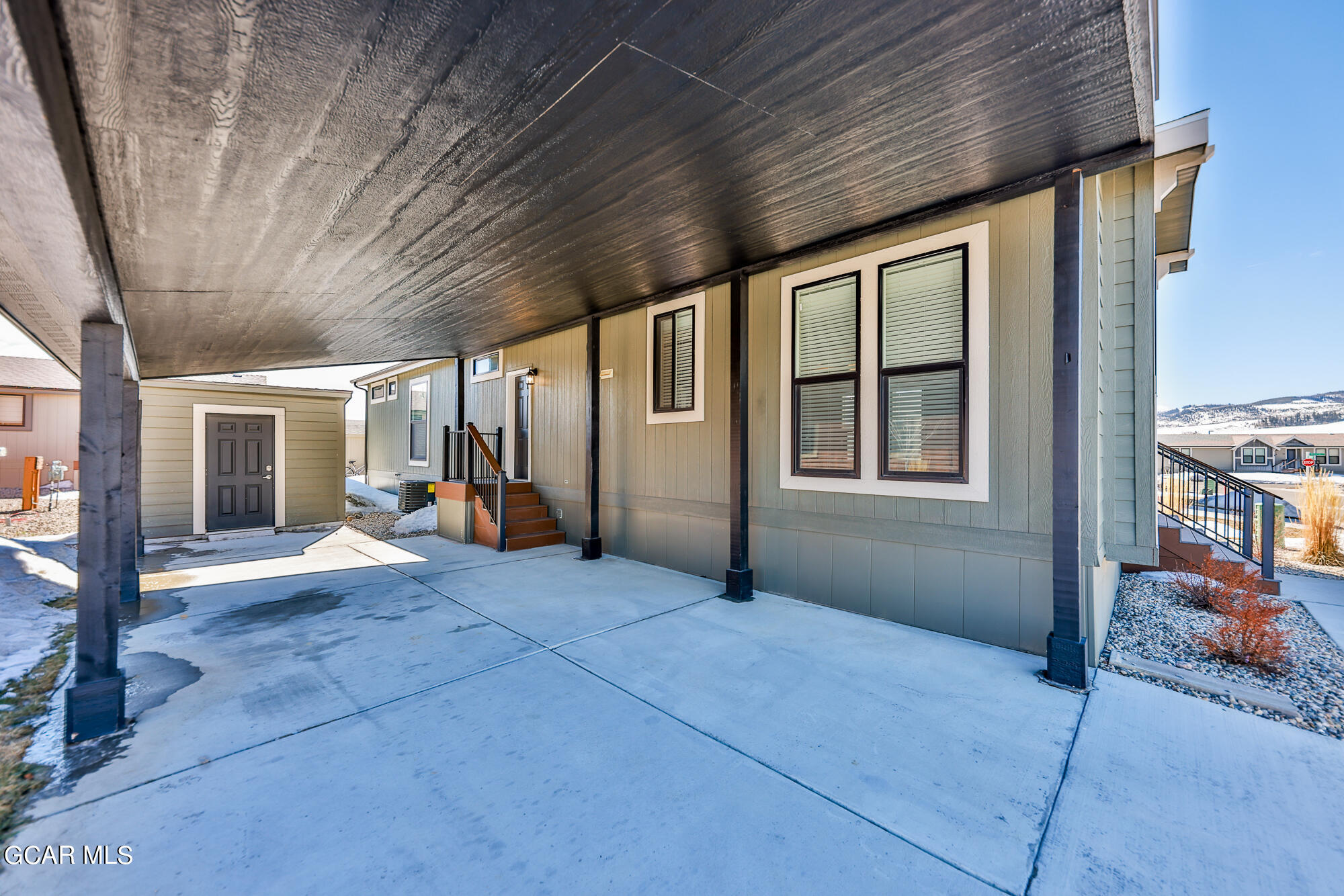 551 Summit Trail, Unit 145 Granby, CO 80446 - Photo 8 of 39 a view of a porch with furniture and floor to ceiling window