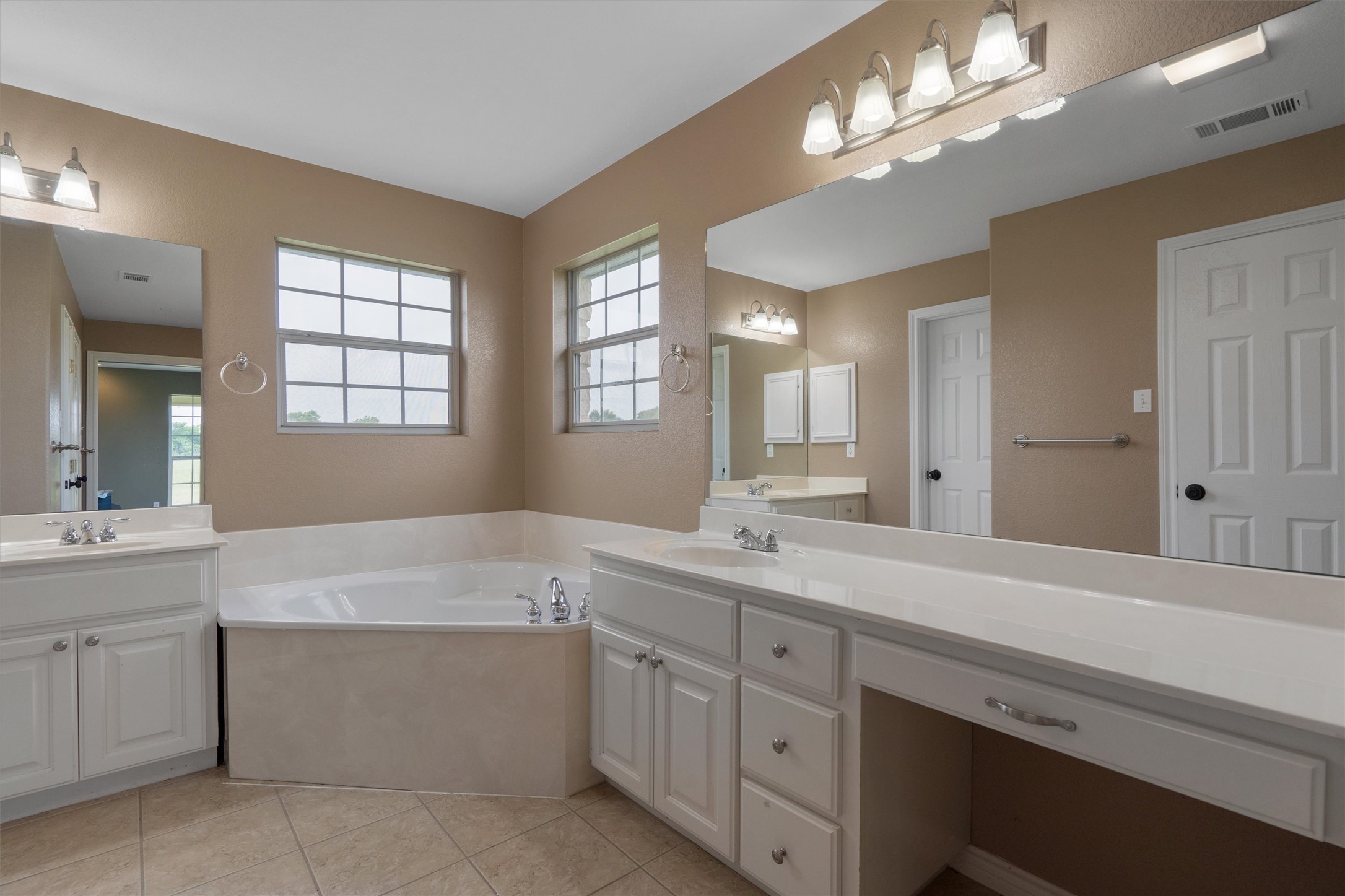 130 Cotton Rows Lane Taylor, TX 76574 - Photo 24 of 32 a bathroom with a sink a vanity a lamp and a mirror