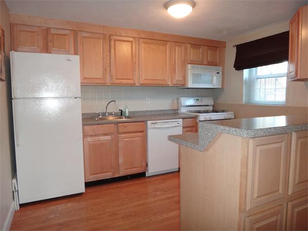 270 Main Street, Unit 2 North Reading, MA 01864 - Photo 1 of 7 a kitchen with stainless steel appliances granite countertop a refrigerator sink and white cabinets