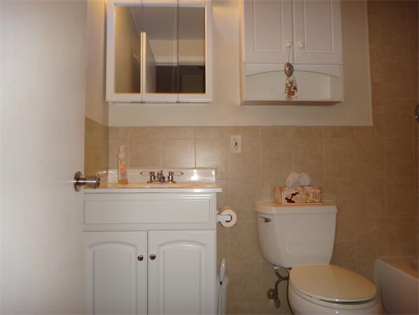 270 Main Street, Unit 2 North Reading, MA 01864 - Photo 2 of 7 a bathroom with a toilet a sink and mirror