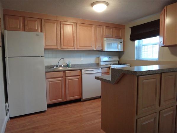 270 Main Street, Unit 2 North Reading, MA 01864 - Photo 3 of 7 a kitchen with a sink a stove a refrigerator and cabinets